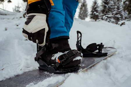 Mens boots and snowboard freerider in mountains. Winter sport, leisure outdoor lifestyleの写真素材