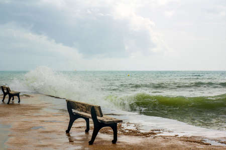 Mediterranean landscape. Benches on the pier filled with water. Spain, Alicante, Costa Blancaの写真素材