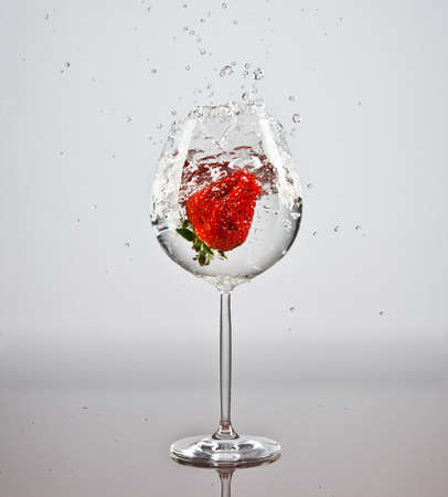 Strawberry in a glass of waterの写真素材