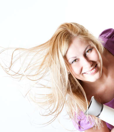 Portrait of a girl with a hairdryerの写真素材
