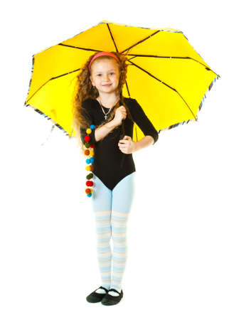 A cute girl holding an umbrella isolated in a white backgroundの写真素材