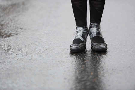 feet on wet asphaltの写真素材