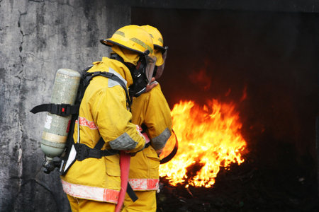 firefighters battling a fire burning in a building