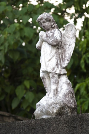 Weathered stone statue of an angel