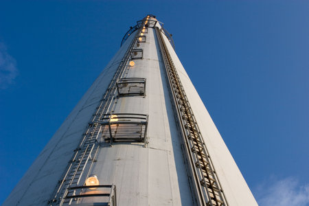 close view of a tall industrial chimney from the ground up, horizontal framing