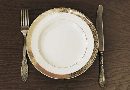 antique fork, knife and plateの写真素材