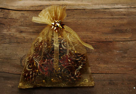 Christmas bag with gifts on wooden wall の写真素材