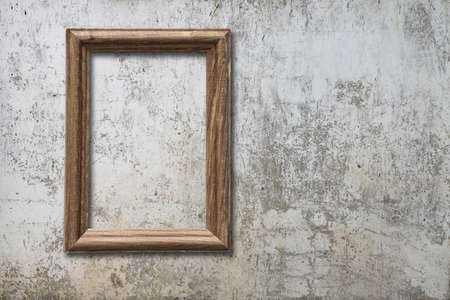 blank photo frame on old wallの写真素材