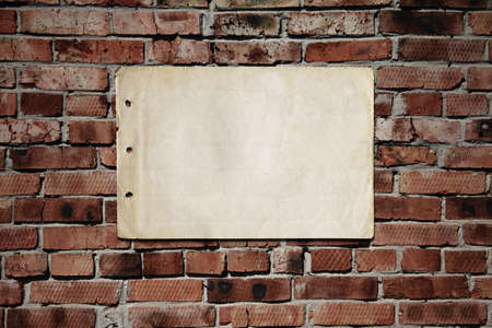 old paper on brickwallの写真素材
