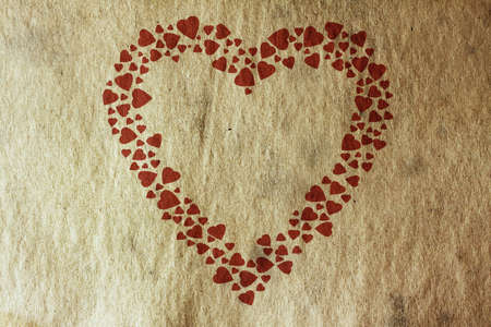 background with vintage heart on old paper texture の写真素材