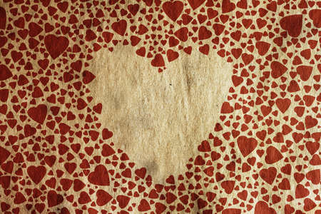 background with vintage hearts on old paper texture の写真素材