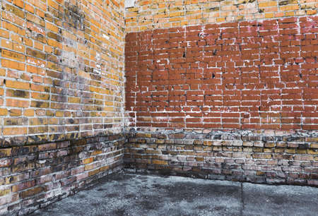 corner of old dirty interior with brick wall, empty room の写真素材