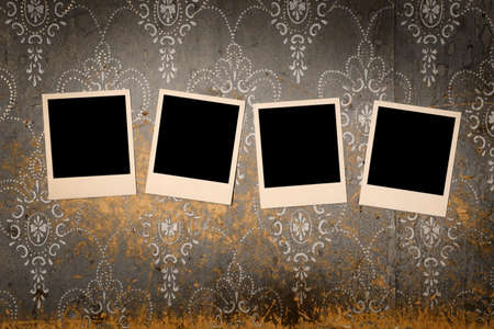 four old photos on old dirty wallの写真素材