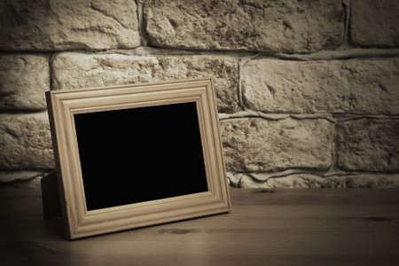 old photo frame on the wooden tableの写真素材
