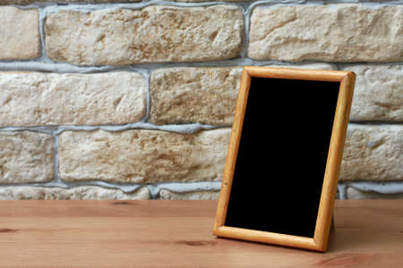 old photo frame on the wooden tableの写真素材