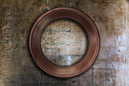 blank photo frame on old wallの写真素材
