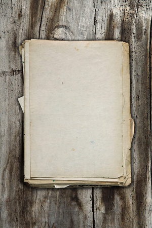 stack of old papers on old wooden background
