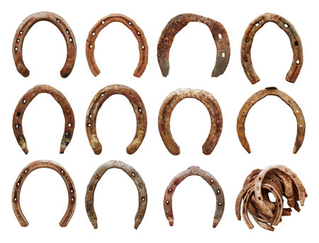 set of old horseshoes on white background の写真素材