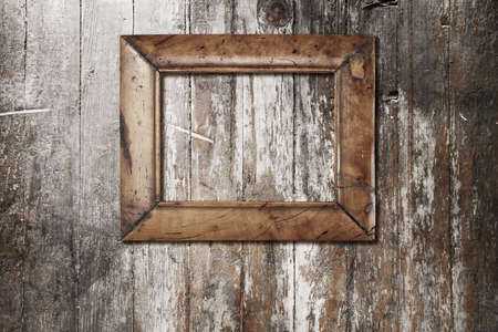 wooden photo frame on old wooden wallの写真素材