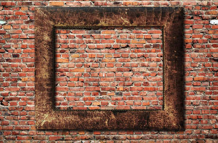 blank photo frame on old brick wallの写真素材