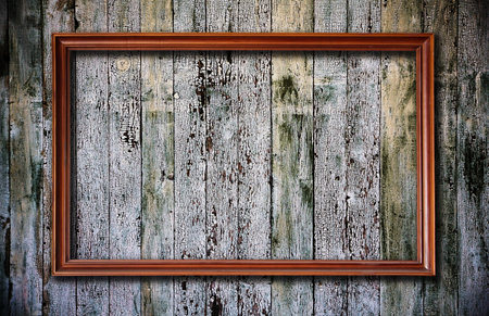 blank picture frame on old wooden background