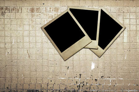 vintage photos on old tile wallの写真素材