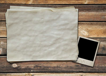 photo and old paper on wooden backgroundの写真素材