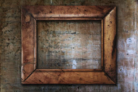 blank photo frame on old wallの写真素材