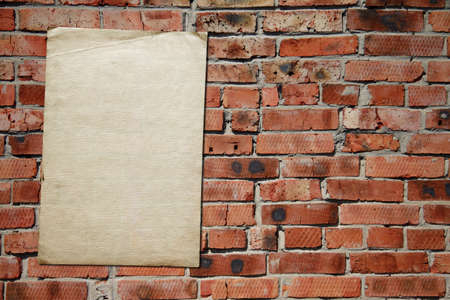 old paper on brickwallの写真素材
