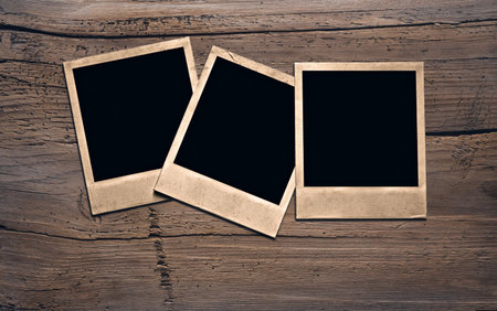 old photos on wooden wall の写真素材