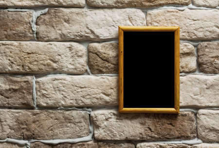 blank photo frame on old brick wallの写真素材