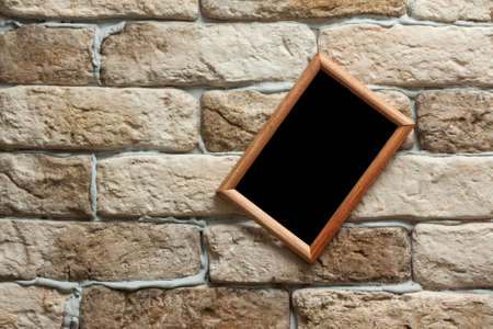 blank photo frame on old brick wallの写真素材