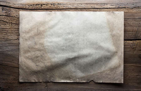 old paper on dirty wooden backgroundの写真素材