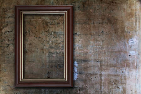 blank photo frame on old wallの写真素材