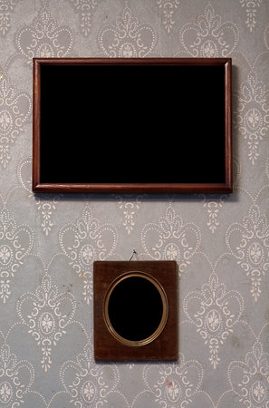 two photo-frames on old wall