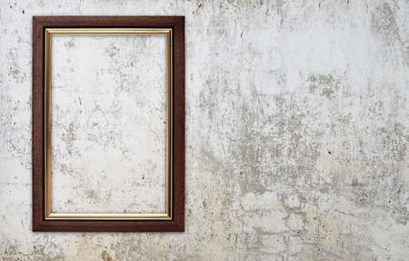 blank photo frame on old wallの写真素材