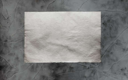old paper on grey dirty wall の写真素材