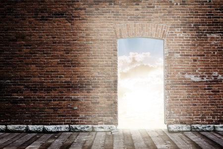 old brick wall with opened door to sunset sky