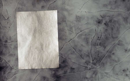 old paper on grey dirty wall の写真素材