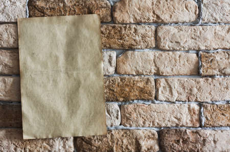 old paper on brick wall の写真素材