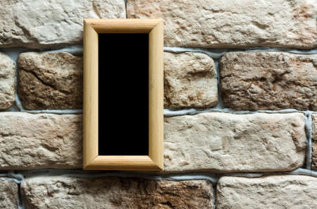 blank photo frame on old brick wallの写真素材