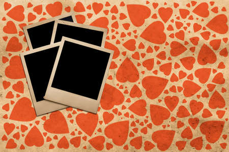 old photo on grunge old paper with heartsの写真素材