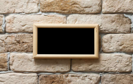 blank photo frame on old brick wallの写真素材