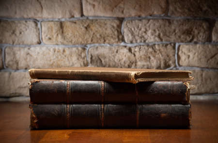 stack of old books on wooden tableの写真素材