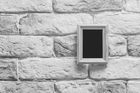 blank photo frame on old gray brick wallの写真素材