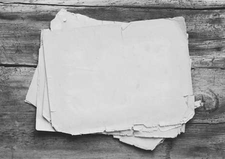 stack of old papers on gray wooden backgroundの写真素材