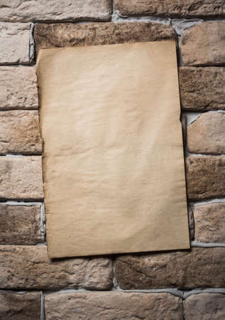 old paper on brick wall の写真素材