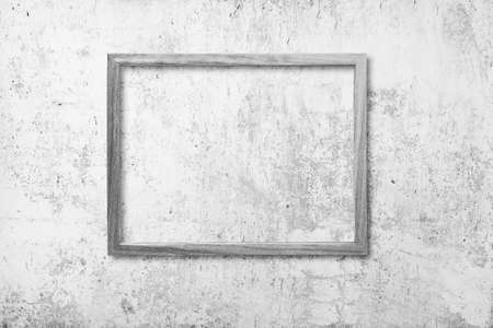 blank photo frame on old gray wallの写真素材