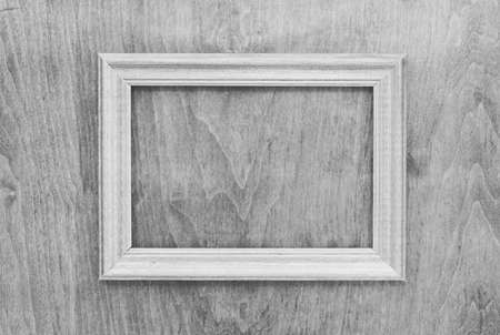 blank photo frame on old wooden gray wallの写真素材