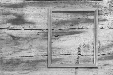 blank photo frame on old wooden gray wallの写真素材